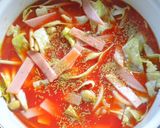 A picture of step 4 of Seafood Tomato Pasta Soup.