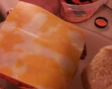 A picture of step 4 of Buffalo chicken bacon sandwich with cheddar jack cheese.