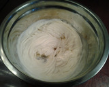 A picture of step 3 of White Butter Cake layered with Raspberry Cream with a White Chocolate Frosting.