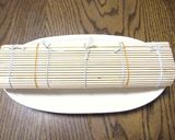 A picture of step 3 of Doll's Festival Seafood Futomaki Sushi Rolls with Nanohana.