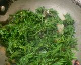 A picture of step 2 of Gajar Saag (Carrot leaves) stir fried with coconut.