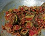 A picture of step 6 of Punjabi bitter gourd rounds in tomato gravy.