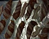 A picture of step 2 of Honey chicken wrapped in bacon.