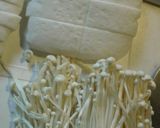 A picture of step 1 of Japanese-style Enoki Mushrooms and Hanpen Fish Cake Wrapped with Sliced Pork.