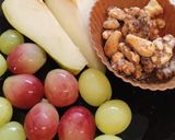 A picture of step 1 of Sliced 🍐 and grapes with walnuts. Healthy Juicy snack.