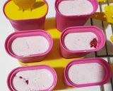 A picture of step 4 of Berry Creamy Popsicles.