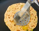 A picture of step 2 of Stuffed Leftover Rice Paratha topped with Schezwan Sauce.