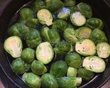 A picture of step 1 of California Farm Black Garlic Poached Brussels Sprouts.