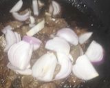 A picture of step 3 of Kibda (Egyptian liver sauce) and French fries.