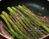 A picture of step 4 of Burnt garlic aspagauraus topped with parmesan cheese.