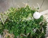 A picture of step 3 of Crispy Gyoza Dumplings with Bean Sprouts and Garlic Chives.
