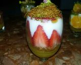 A picture of step 6 of Kunafa and Qashtalia Decorated with Oranges, Strawberries, and Bananas.