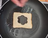 A picture of step 4 of Savoury Rosemary Flower Egg in a Hole.