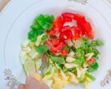 A picture of step 4 of Ajwain leaf salad with veggies and pineapple.