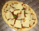 A picture of step 3 of Tex's 2 Pig Pizza 🍅🐷🧀🍕🌿.