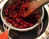 A picture of step 2 of pomegranate syrup on ice cream.
