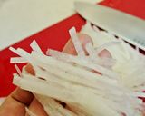 A picture of step 2 of Simple Daikon Radish & Crab Stick Salad.