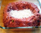 A picture of step 4 of Meatloaf with rice in the middle.