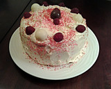 A picture of step 12 of White Butter Cake layered with Raspberry Cream with a White Chocolate Frosting.
