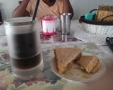 A picture of step 4 of Leftover veg sandwhich with iced coffee.