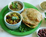 A picture of step 9 of Lunch is served: South Indian Thali with Potato Masala puri, Kidney Beans Koottu, and Green Chutney.