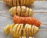 A picture of step 5 of Spiral potato and carrots on stick.