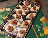 A picture of step 4 of Ham, Olive, Anchovy, and Tomato 'Eye' Canapés.