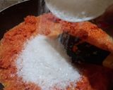 A picture of step 2 of Gajar Ka Halwa with milk and cashews.