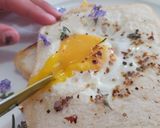 A picture of step 7 of Savoury Rosemary Flower Egg in a Hole.