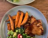 Sticky bbq chicken thighs served with sweet potato chips and a crisp lemon salad