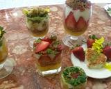 A picture of step 14 of Kunafa and Qashtalia Decorated with Oranges, Strawberries, and Bananas.