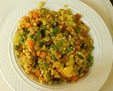 A picture of step 4 of Upma with puffed rice and colorful veggies.
