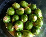 A picture of step 2 of My Roasted Sprouts in orange,crushed Walnuts and Cranberry sauce.