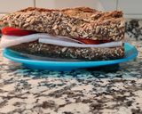 A picture of step 4 of Seven-Grain Bread Sandwich with Turkey Breast and Peppers.