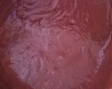 A picture of step 5 of Red velvet cake with a chocolate ganache cream frosting.
