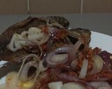 A picture of step 2 of Fried Tilapia fish with onion sauce.