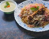 A picture of step 9 of Smokey tandoori chicken drumsticks biryani with mint mango raita.