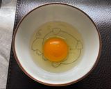 A picture of step 6 of Jah Jan Mien (instant packet noodles) with peanut butter, spring onions topped with fried egg.
