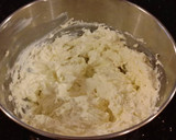 A picture of step 12 of Vanilla Lemon Raspberry Layer Cake with Whipped Cream Buttercream Frosting.
