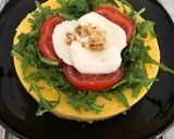 A picture of step 4 of Savory Polenta Tart with Pesto, Ricotta, Arugula, Tomatoes, Mozzarella, and Walnuts.