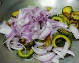 A picture of step 4 of Punjabi bitter gourd rounds in tomato gravy.