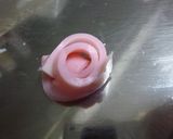 A picture of step 3 of Onigiri with a Kamaboko Rose.