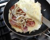 A picture of step 8 of My Folded Omelette with Bacon, Onion and Cheese Inside, Topped with Grated Mozzarella 😘.