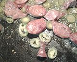 A picture of step 2 of Spicy eggs, with sausage.