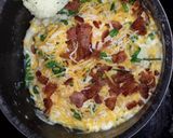 A picture of step 8 of Breaded pork loin chops with a side of mashed potatoes topped with bacon, cheese,green onion.