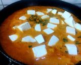 A picture of step 4 of Paneer Butter Masala with fresh cream.