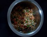A picture of step 2 of Rava Uttapam with veggies, packed with fruits and dryfruits.