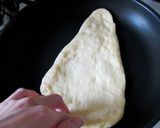 A picture of step 7 of Light and Puffy Homemade Naan Bread in a Pan.