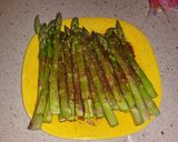 A picture of step 2 of Sticky Asian pork ribs with grilled asparagus over red wine feta aioli.