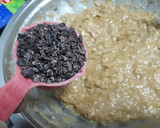 A picture of step 6 of Easy Banana bread with cocoa nibs and blueberries.